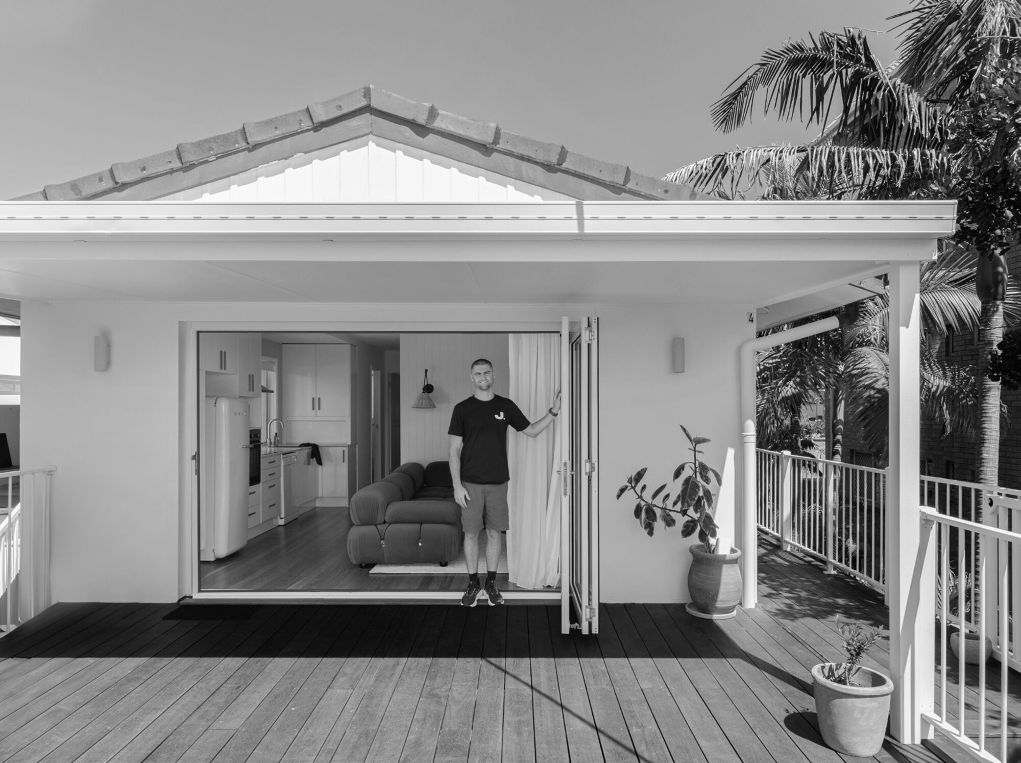 Jace Space founder standing in the doorway of a completed Gold Coast home