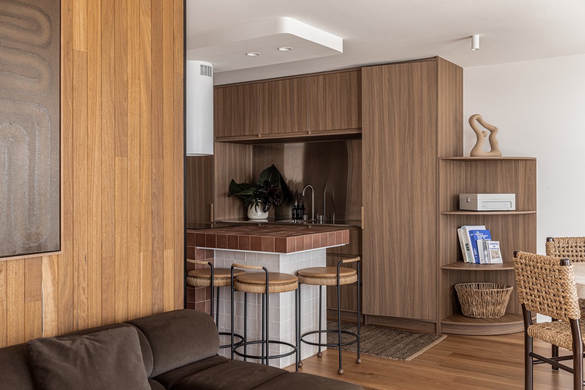 Walnut-panelled kitchenette with a terracotta-tiled servery and built-in shelving