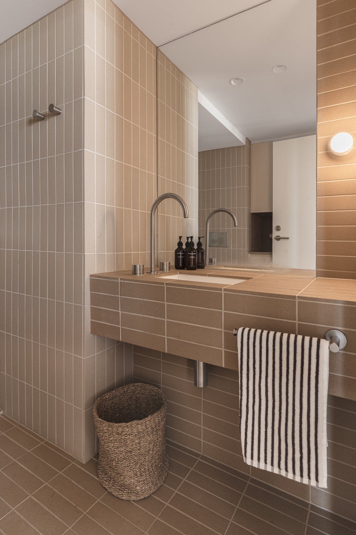 Kitchenette sink and tapware set into a stainless steel benchtop