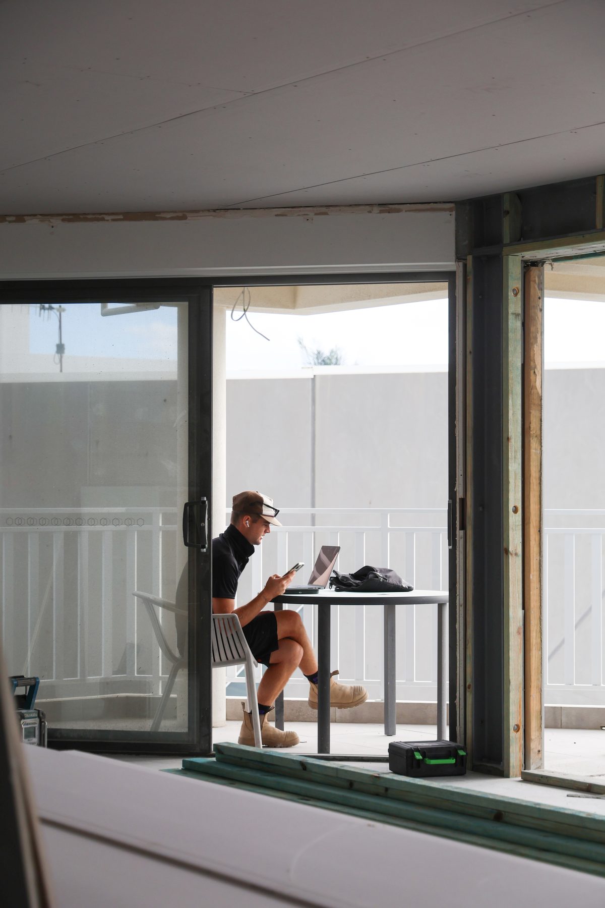 A Jace Space team member on site, staying connected with a client between tasks